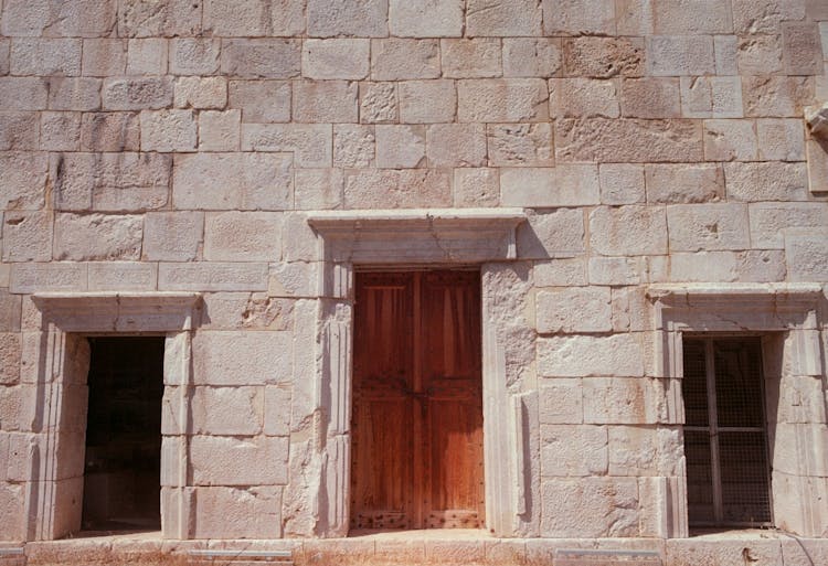 Wooden Double Doors On A Stone Building