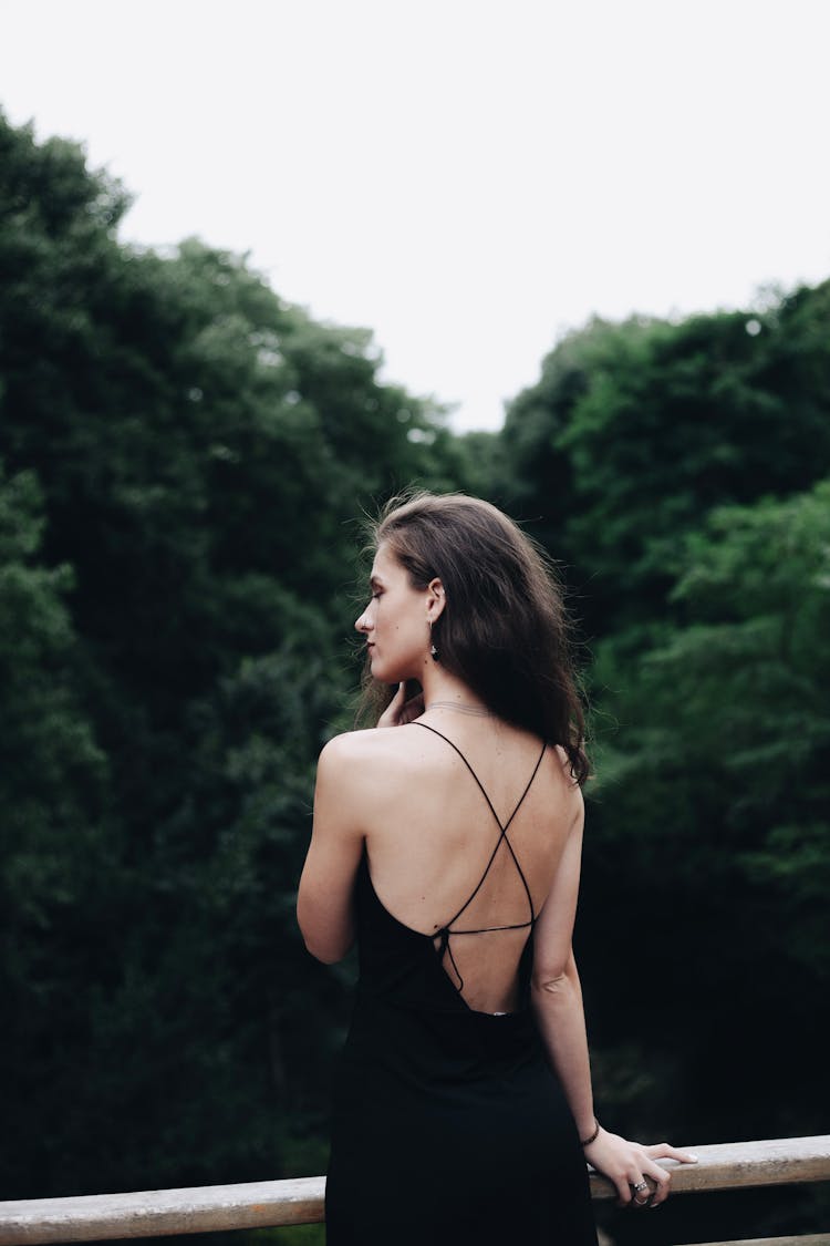 Back Of A Woman Leaning On A Railing