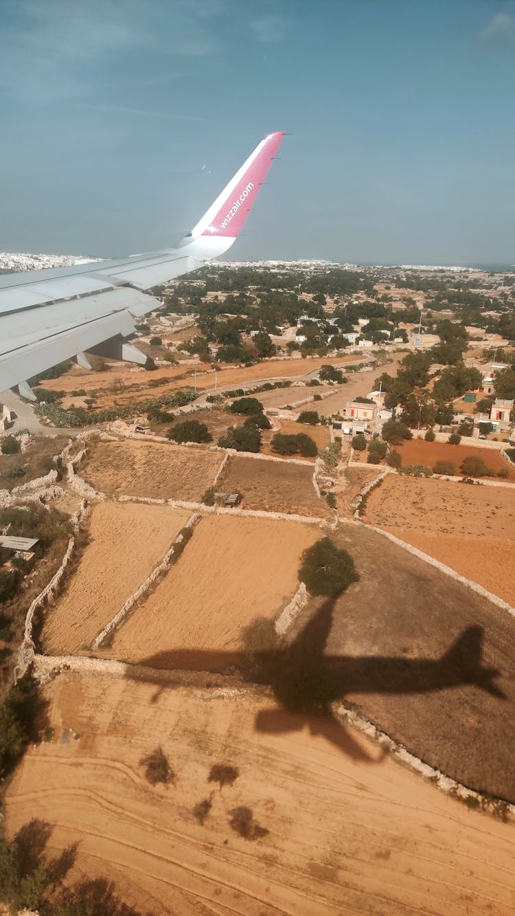 Shadow Of Airplane On Agricultural Fields