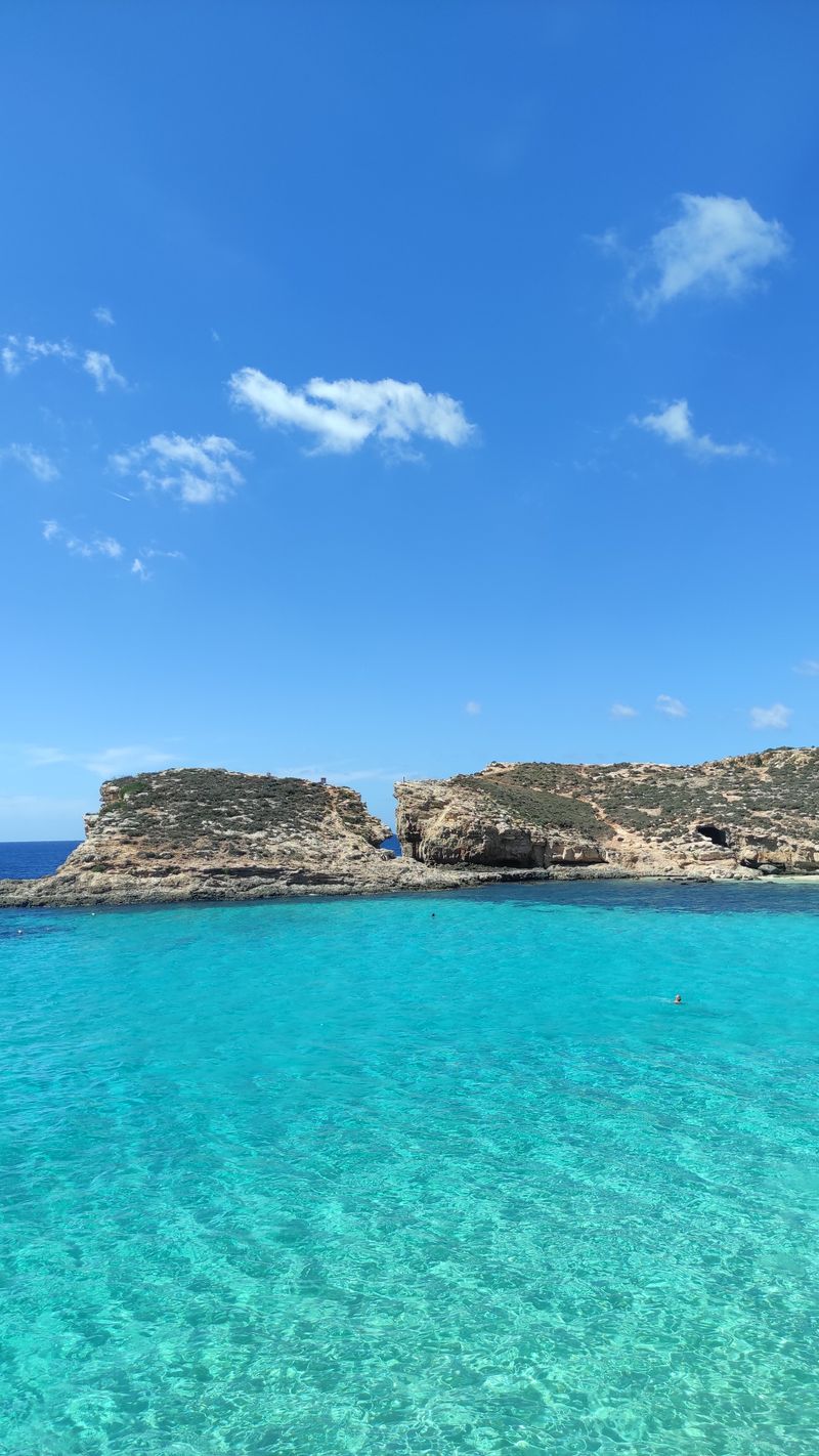 Turquoise water and limestone cliffs at the Blue Lagoon on Comino, Malta