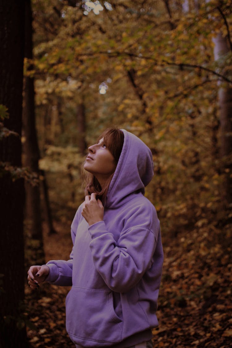 A Woman Wearing A Hoodie In Autumn