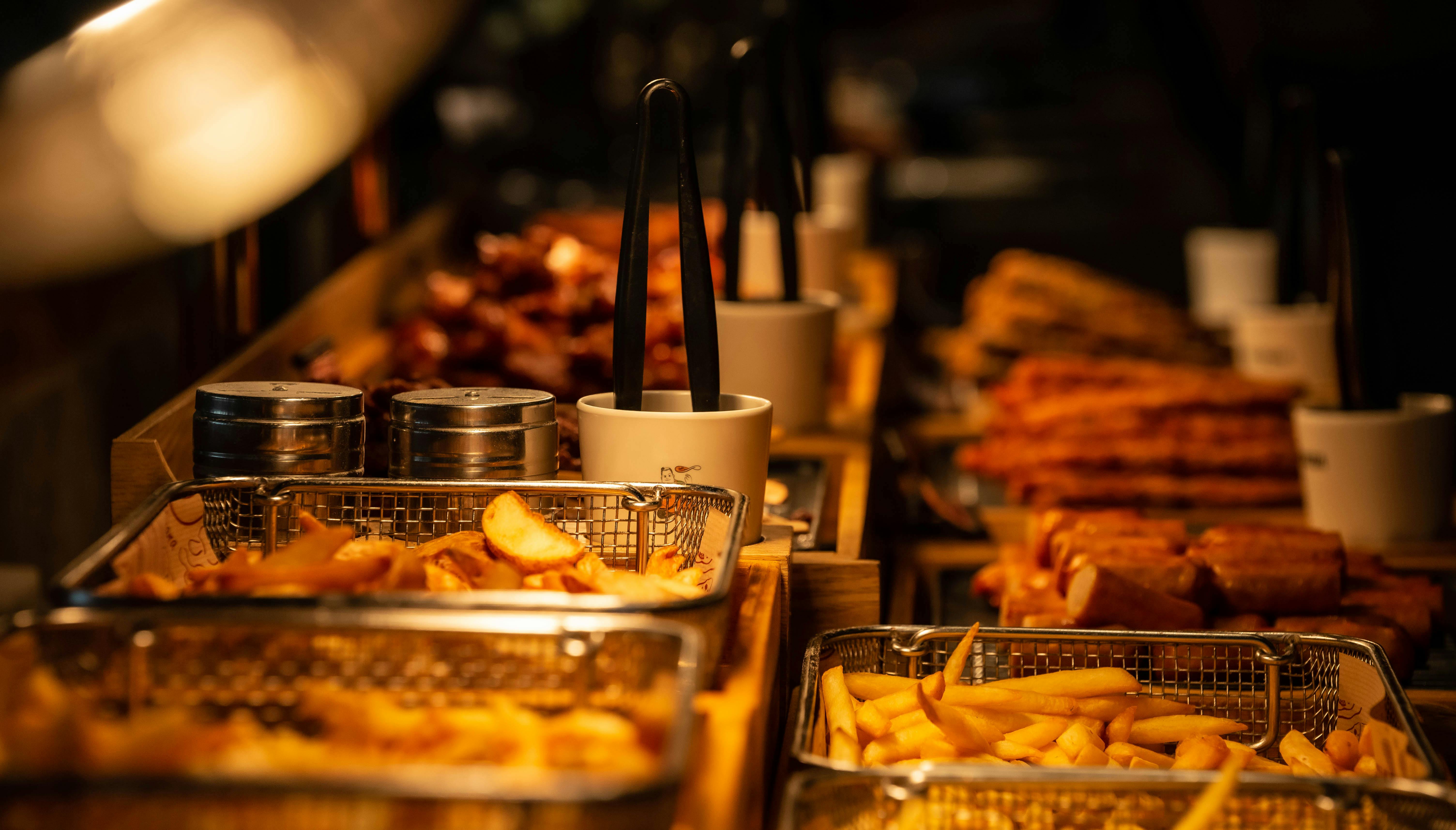 A close-up shot of various fried foods in baskets, perfect for street food lovers.