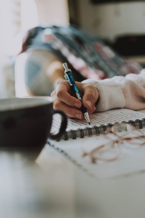 Person Sketching on Paper