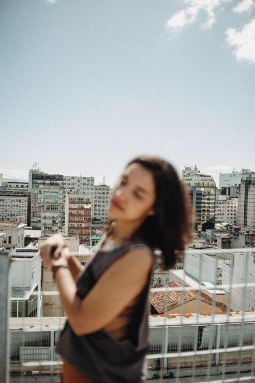 Free Blurry portrait of a woman with urban background in Niterói, Brazil, under clear sky. Stock Photo
