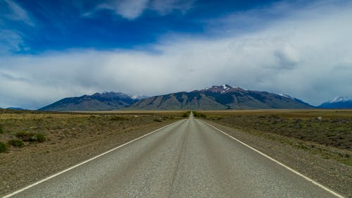 Road in a Plateau, and Mountains on the Horizon