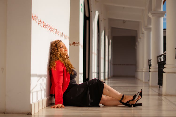 Woman Sitting On Floor Tiles