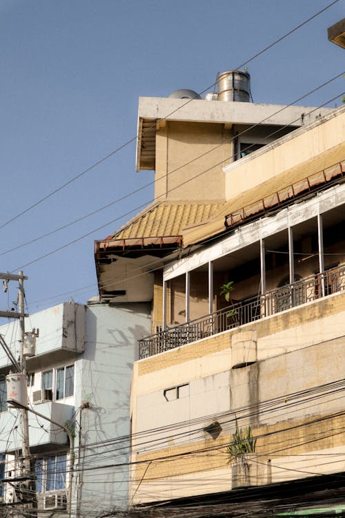 Brown Apartment Building Under Blue Sky