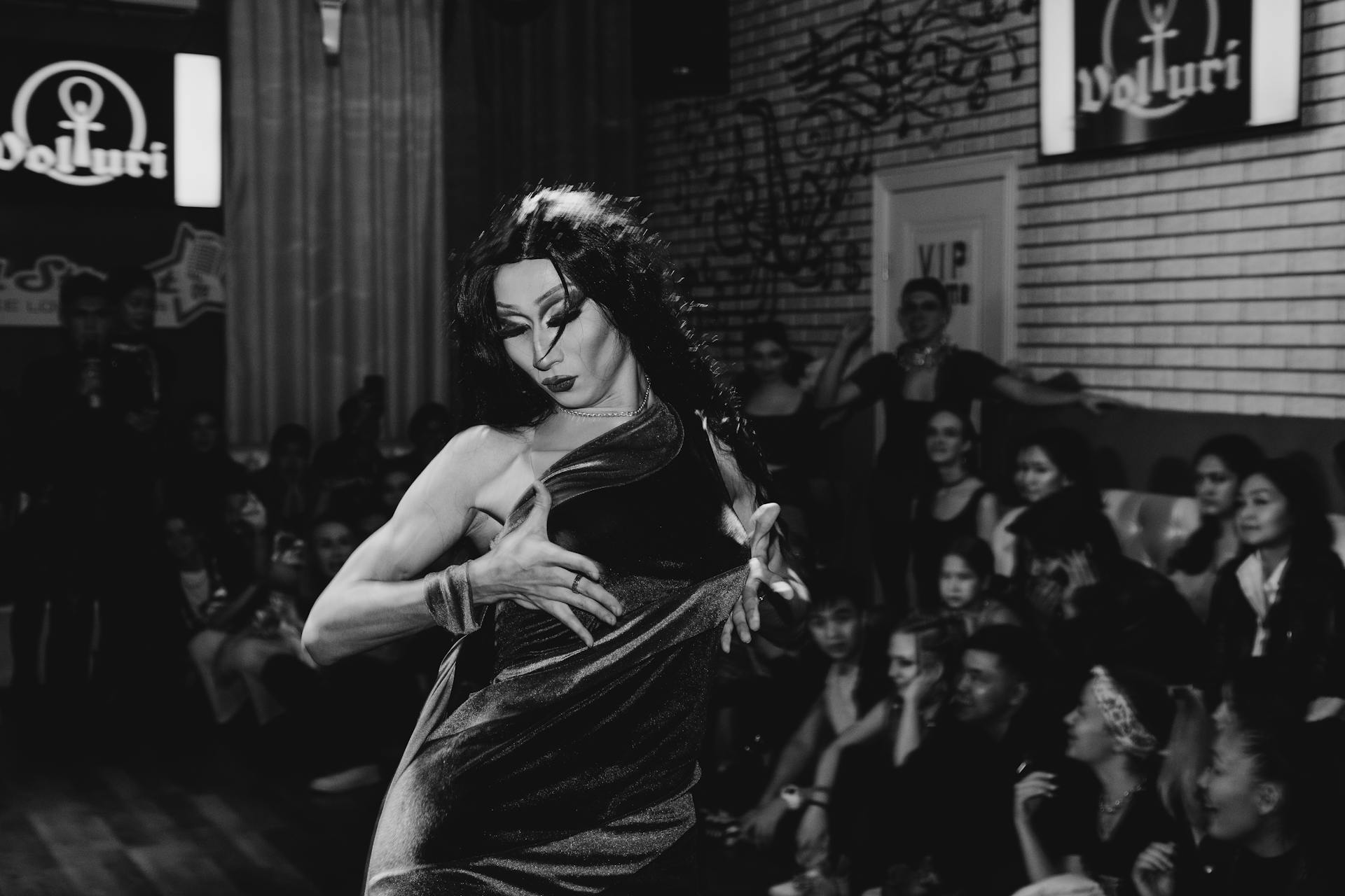 Grayscale Photo of a Drag Queen Performing