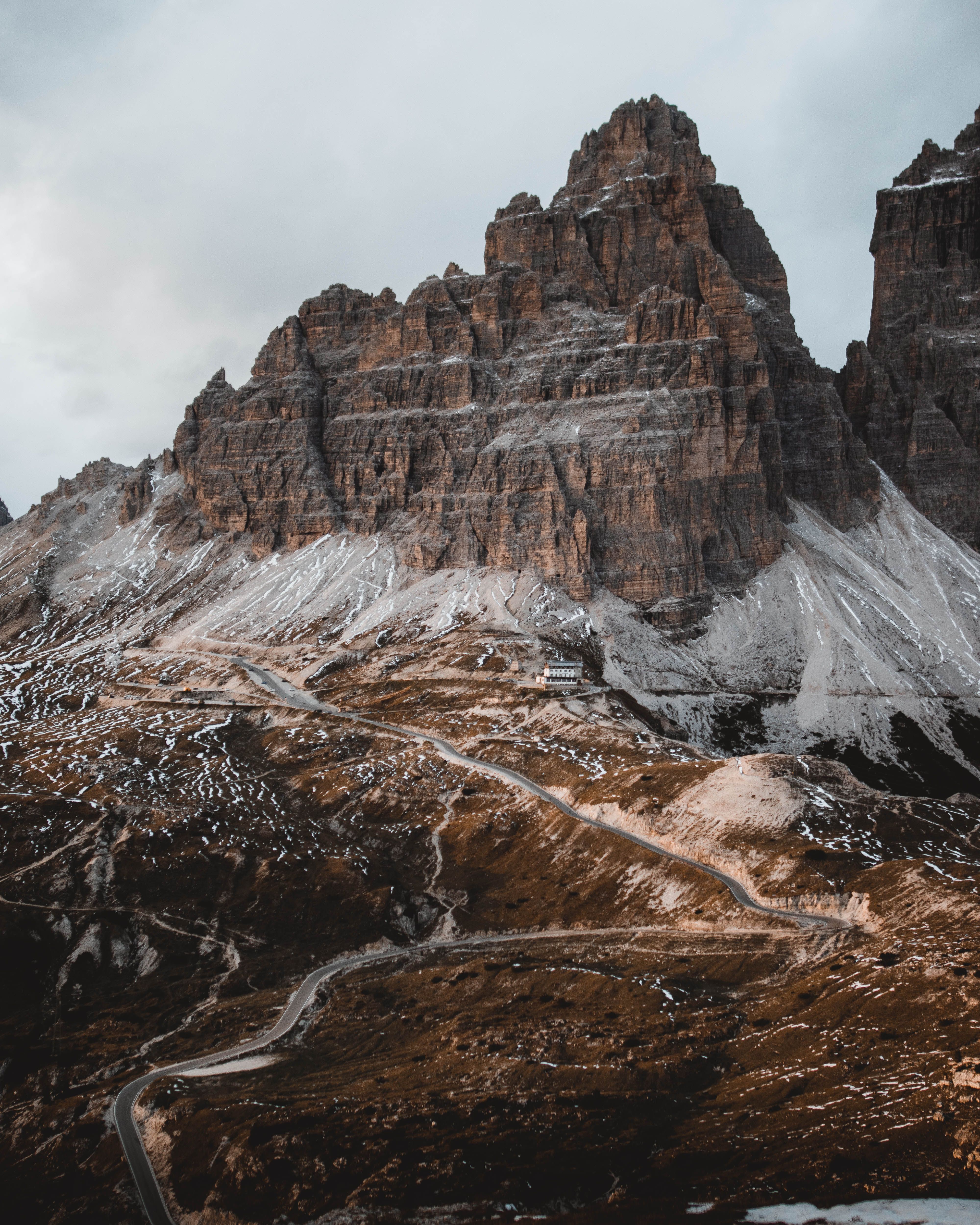 Dramatic view of the Three Peaks of Lavaredo in the Dolomites, Italy with rugged terrain.