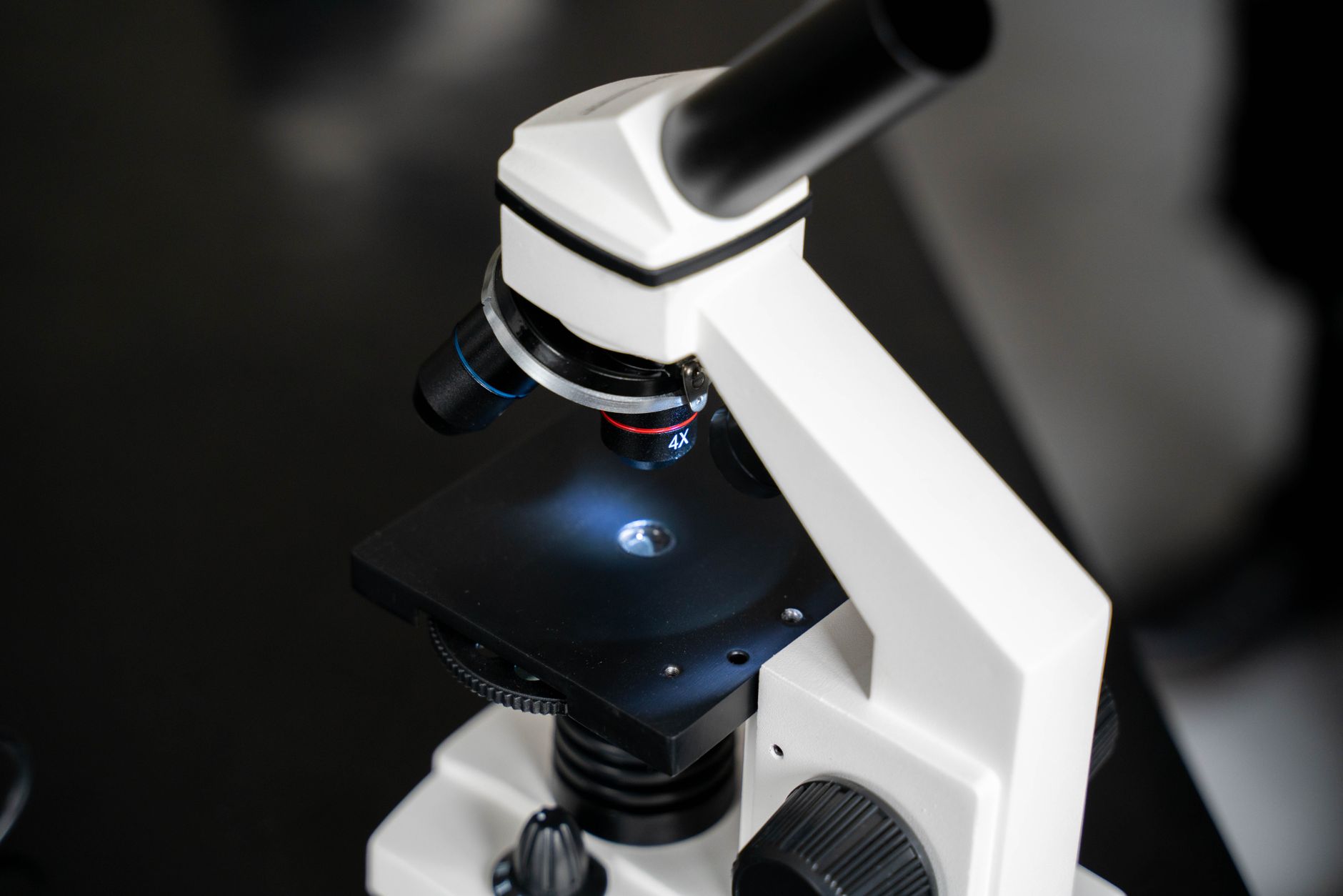 Close-up view of a laboratory microscope with selective focus, ideal for scientific use.