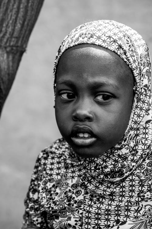 Grayscale Photo of a Child Wearing Hijab