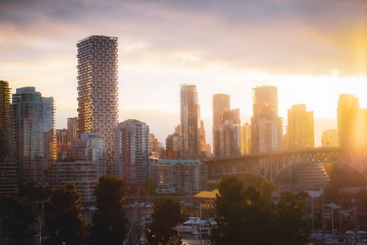 Beautiful skyline of Vancouver, BC with skyscrapers at sunset creating a warm urban ambiance.