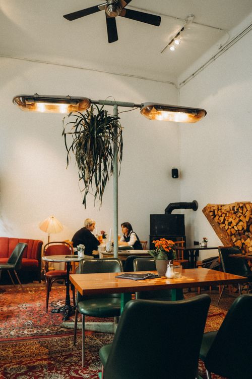 Free A cozy cafe interior with warm lighting, wooden decor, and seating areas, perfect for relaxation. Stock Photo