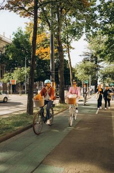 People biking and walking on a sunny day in Vienna, Austria's urban landscape.