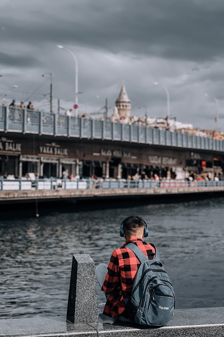 A Man Wearing Backpack And Headphones