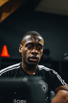 Close-up of an African American man concentrating during a workout session at the gym.