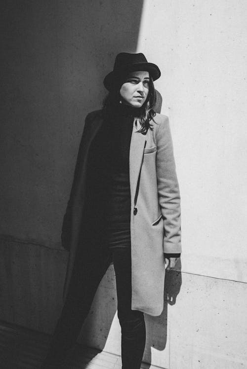 Grayscale Photo of a Woman in a Coat