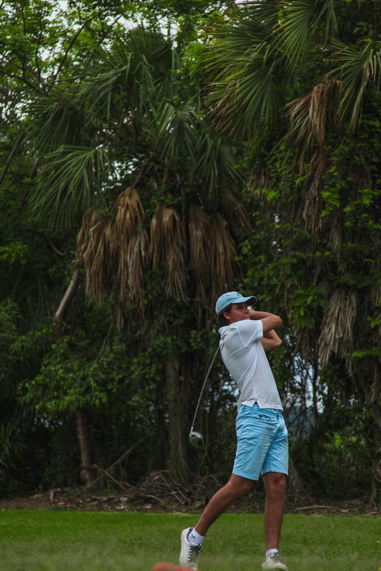 Man Playing Golf In Green Grass