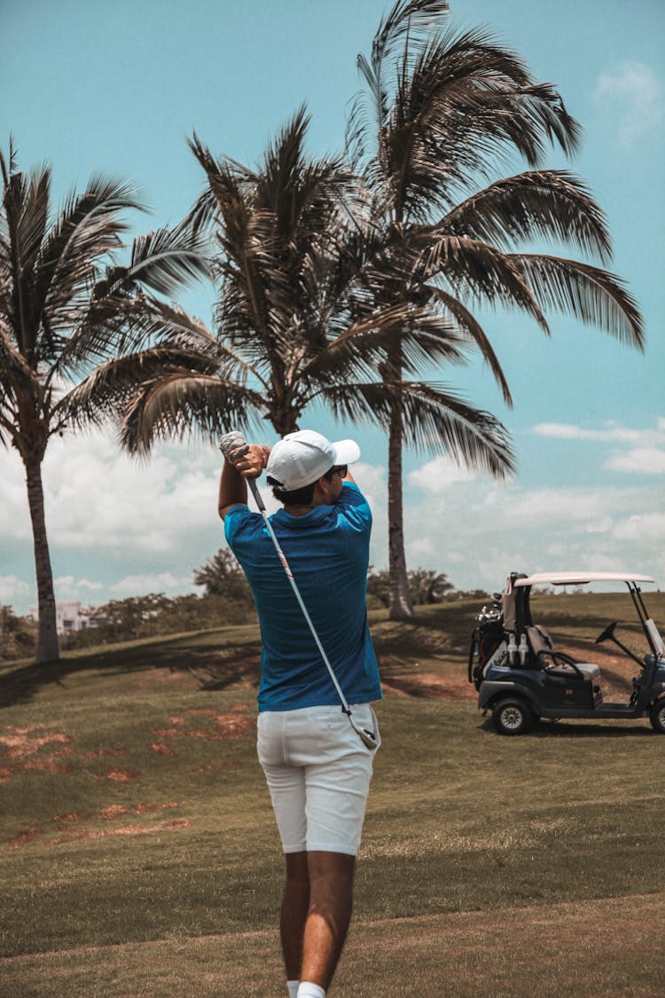 Man In Blue Polo Shirt Playing Golf