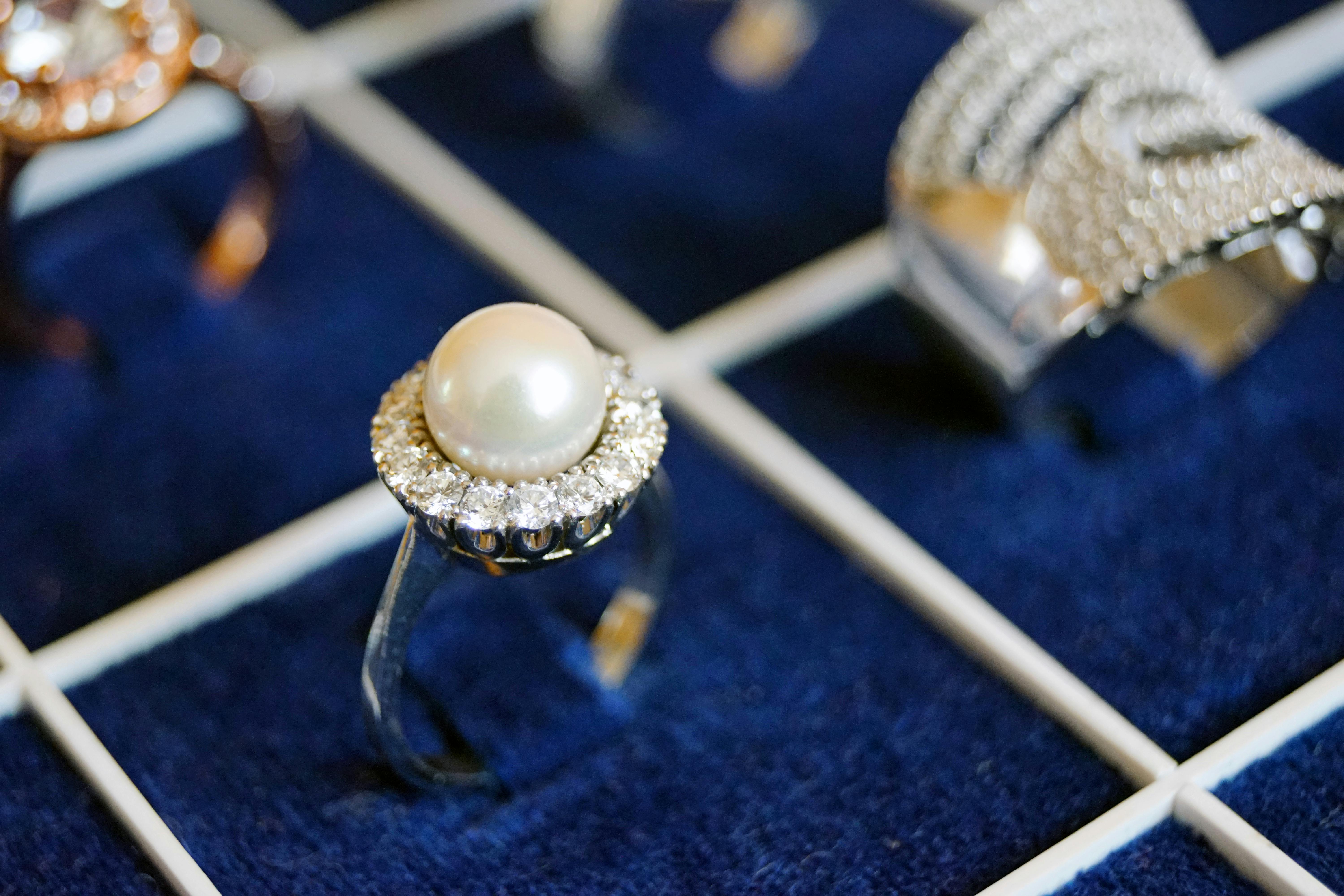 white pearl ring on blue surface