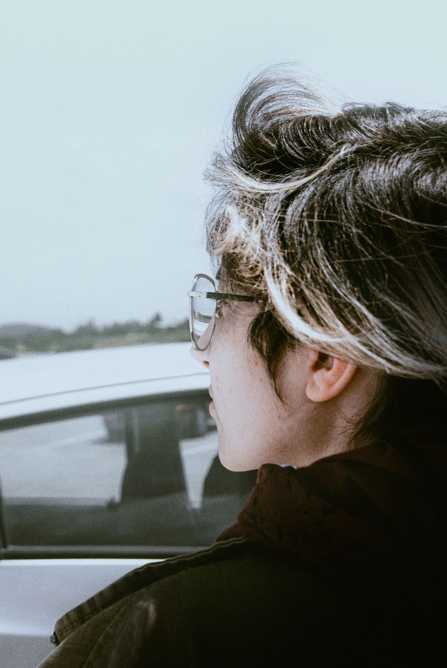 Person wearing optical frames outdoors