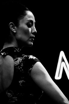 Artistic black and white side profile portrait of a woman wearing pearl earrings, embodying grace.