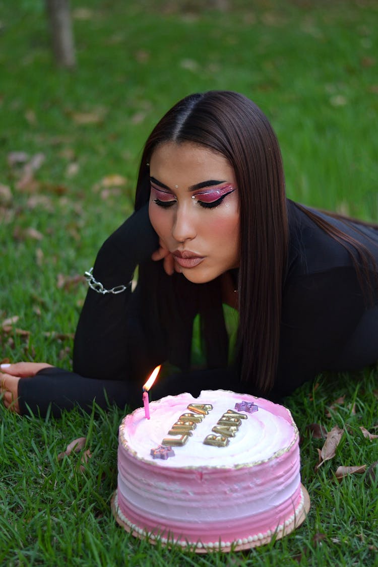 Woman Blowing Candle On Birthday Cake