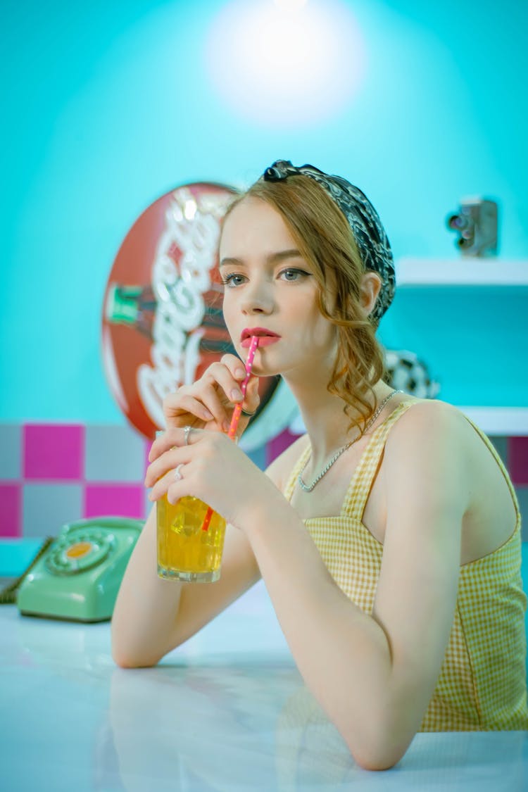 A Woman Drinking At A Bar