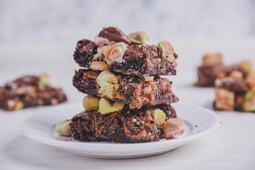 Delicious chocolate brownies with nuts and marshmallows stacked on a plate. Perfect indulgence!