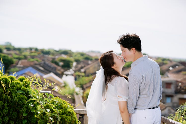 A Couple Kissing Each Other With Eyes Closed