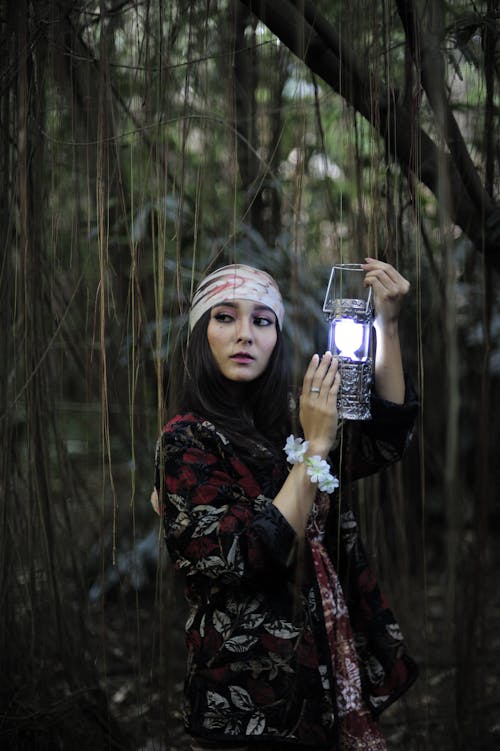 Woman Holding Lantern Lamp on Forest