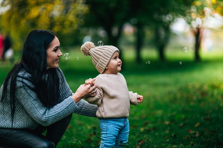 A Mother With Her Child In A Park 