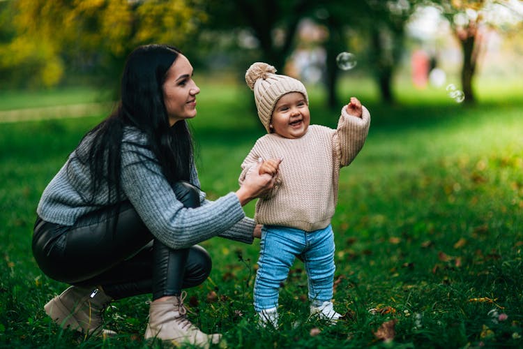 A Woman With Her Child In A Park 