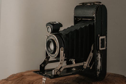 A classic folding bellows camera with a rustic finish, perfect for vintage photography enthusiasts.