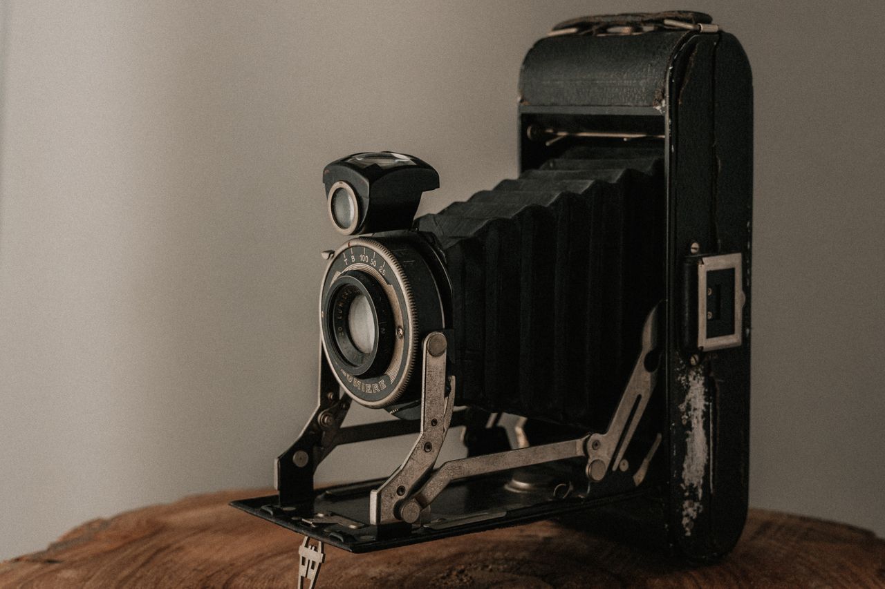 a classic folding bellows camera with a rustic finish perfect for vint