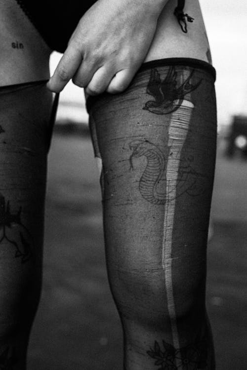 Free Black and White Photo of Legs in Ripped Thighs Stock Photo