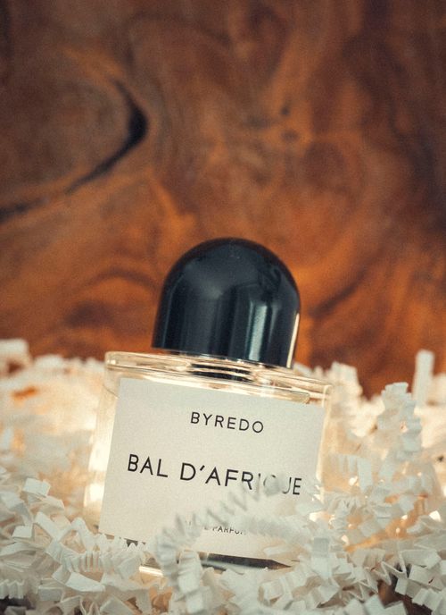 Free Stylish product photo of Byredo Bal d'Afrique perfume bottle amidst paper shreds, radiating luxury. Stock Photo
