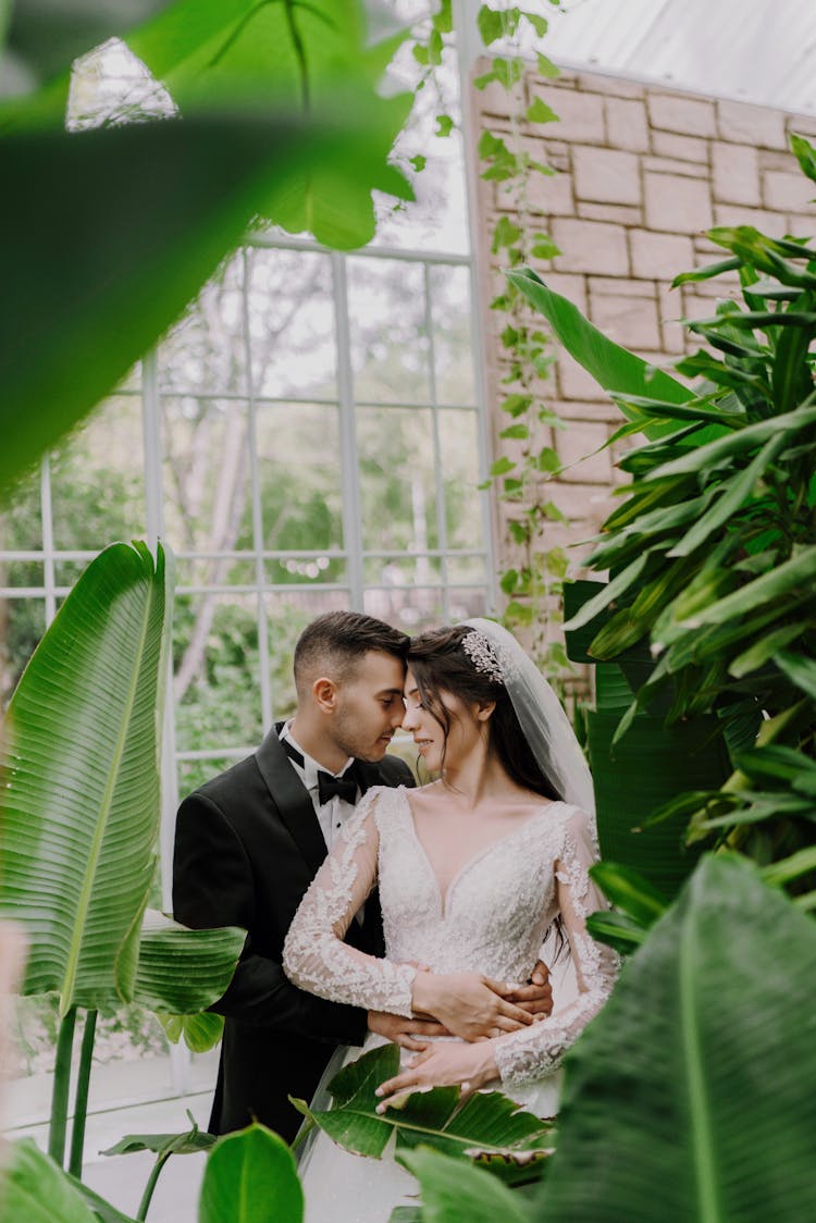 Newlyweds Hugging Among Leaves