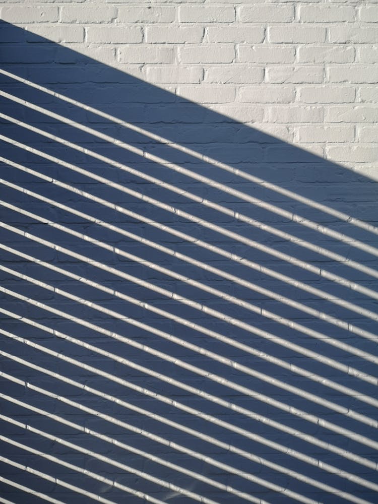 Shadow Of Lines On The White Brick Wall 