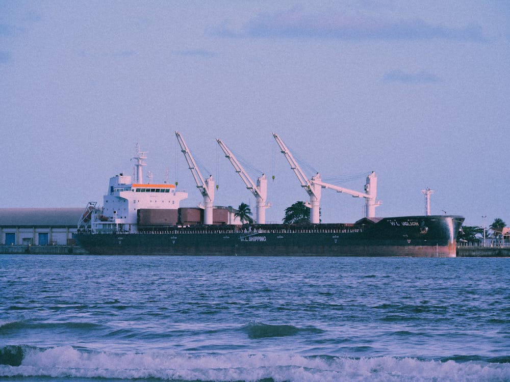 Black Cargo Ship on Sea Near Dock