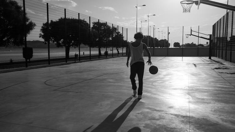 Black And White Photo Of Man Playing Basketball