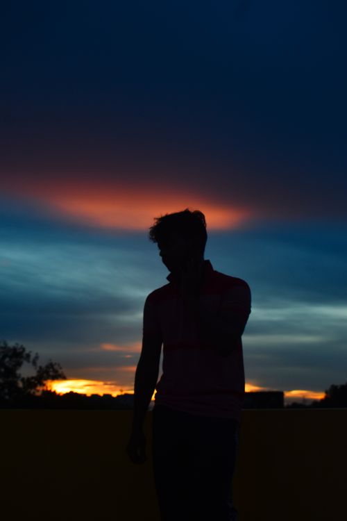 Free A stunning silhouette of a man against a colorful sunset sky in Bhubaneswar, India. Stock Photo