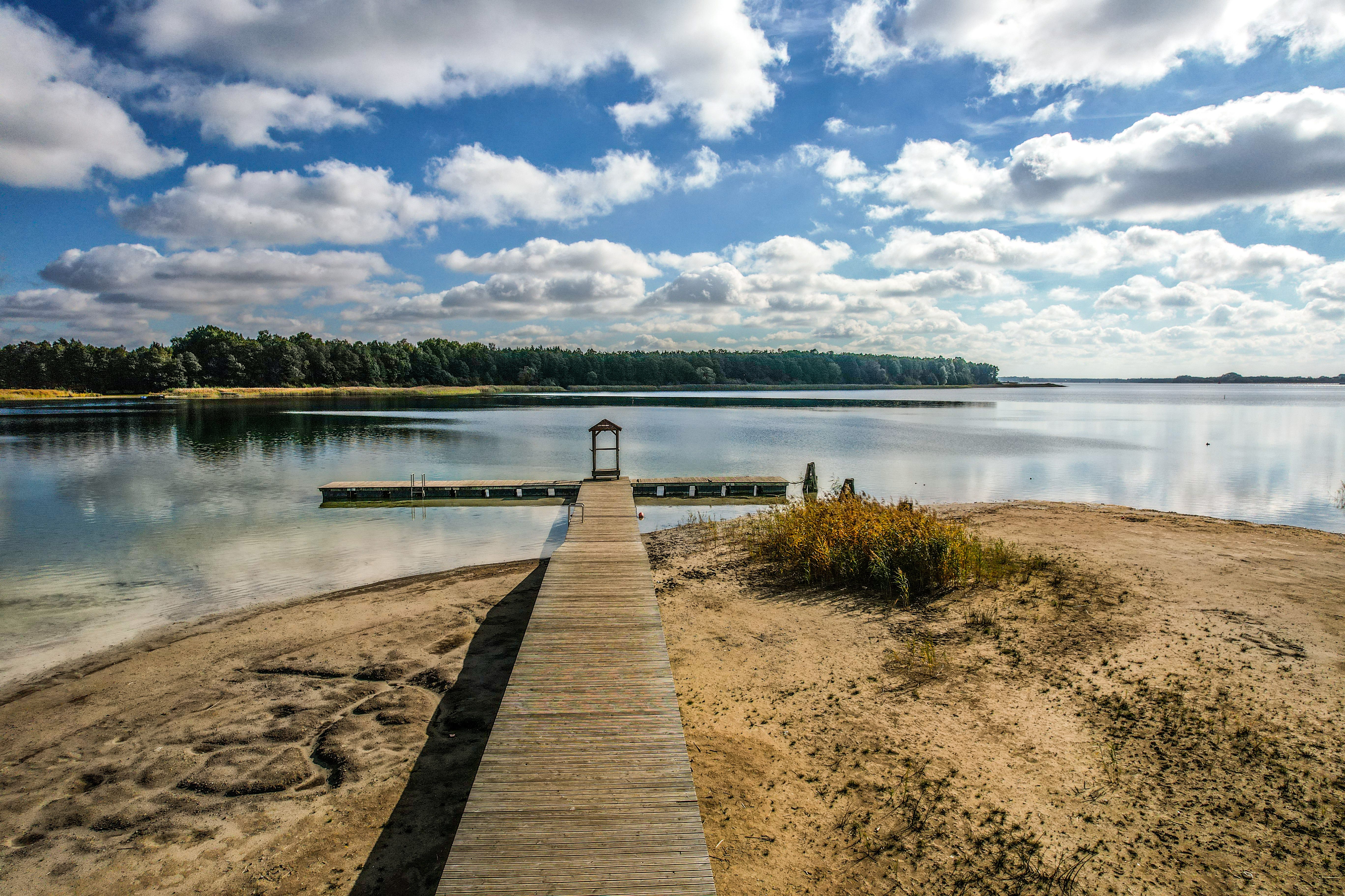 A Wooden Dock on the Lake Under Clouds Sky · Free Stock Photo