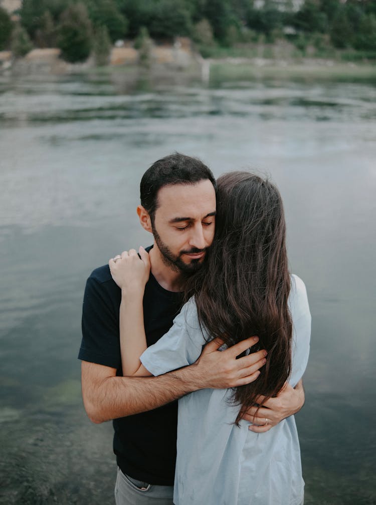 Couple Hugging By The Lake 