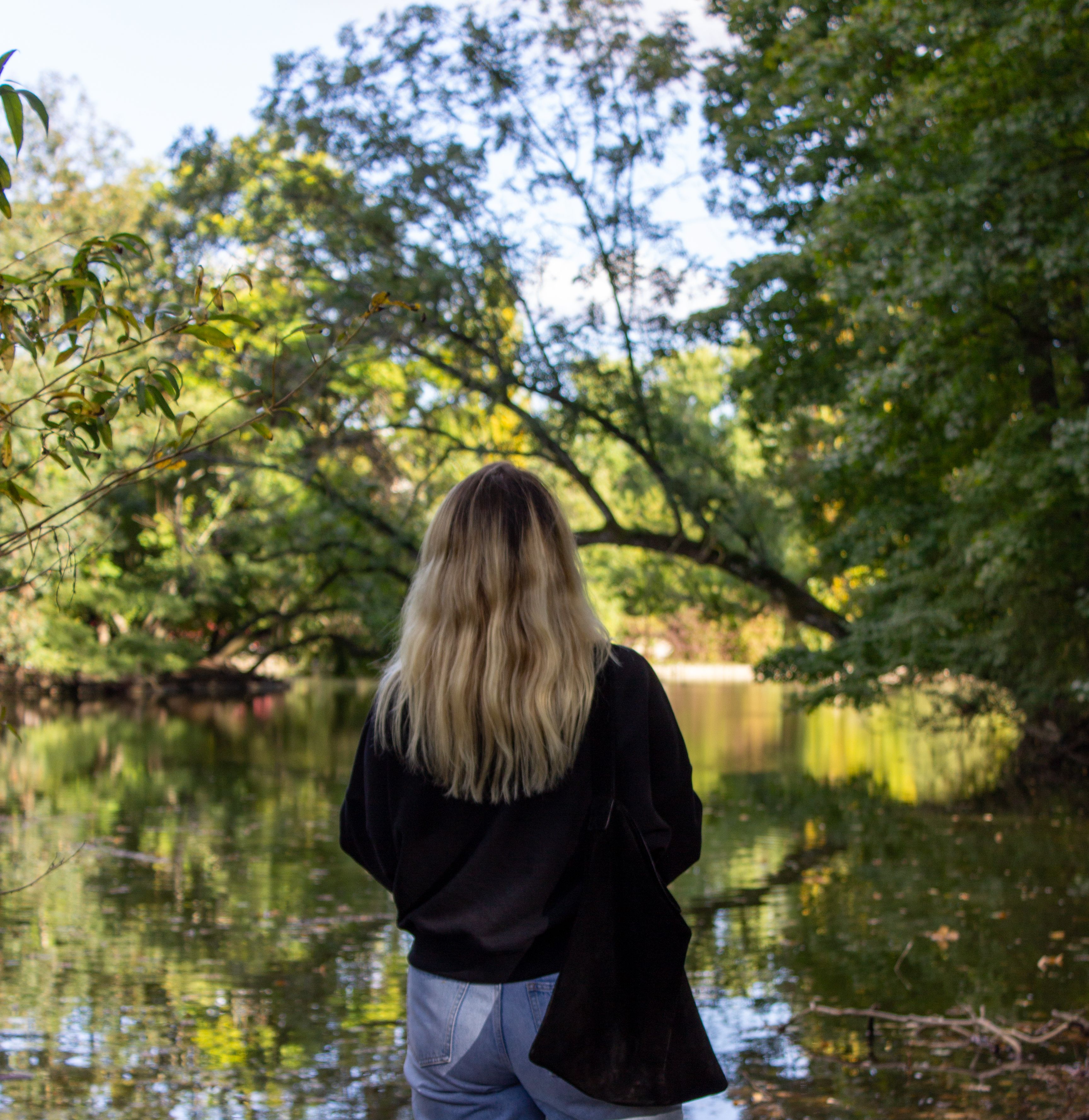 Back View of a Woman Black Sweater and Black Cap · Free Stock Photo