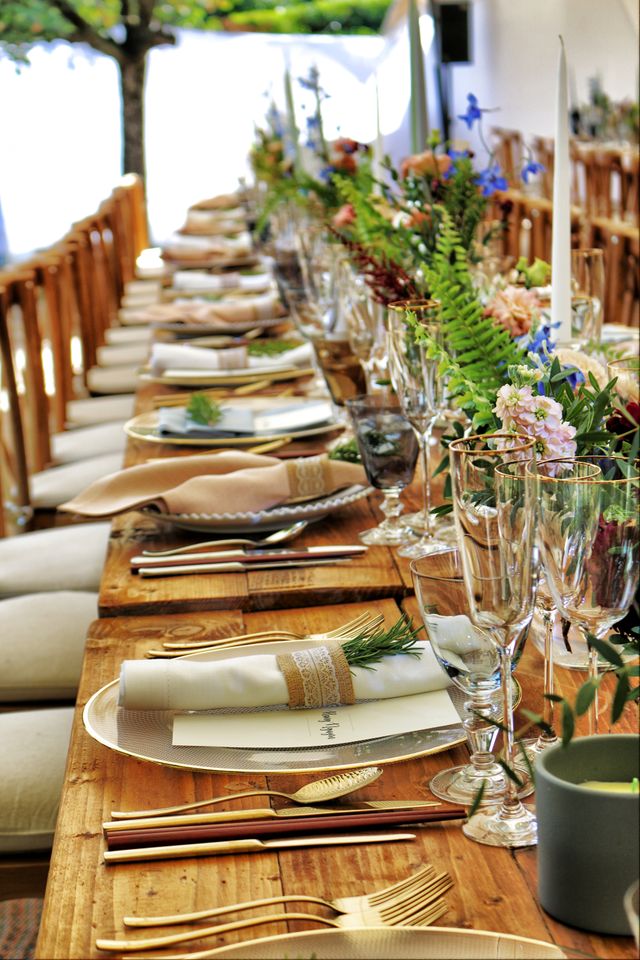 Elegant banquet table set with flowers, candles and fine glassware