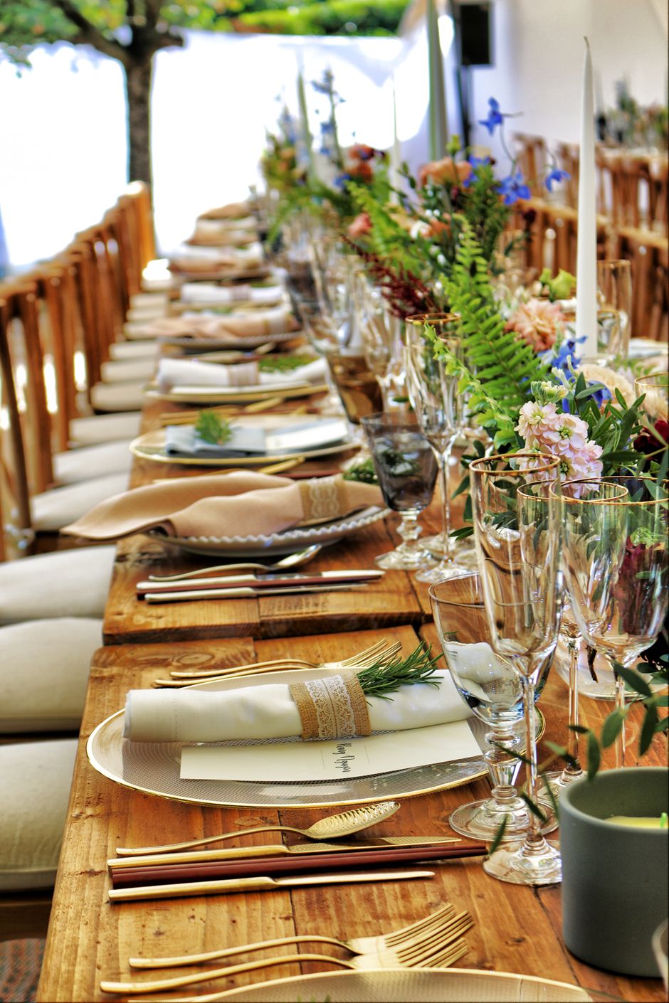 Elegant banquet table set with flowers, candles and fine glassware