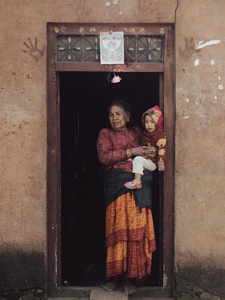 Elderly Woman Carrying A Baby