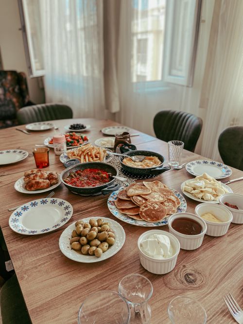 Free A vibrant breakfast spread featuring pancakes, spreads, and olives on a wooden table. Stock Photo