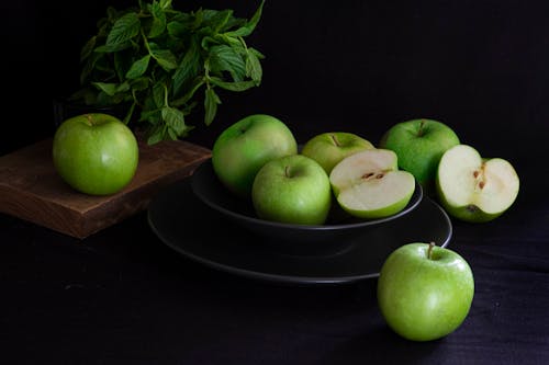 Green Apples on Black Ceramic Plate